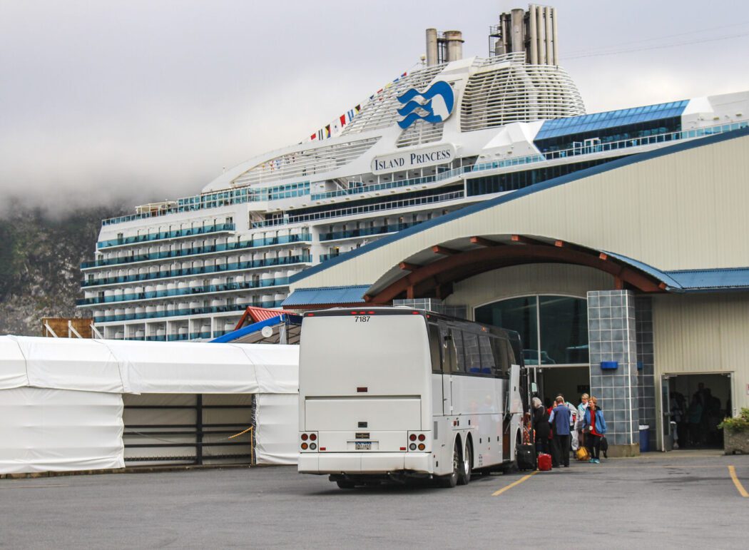 Passengers arrive in Whittier, Alaska by motor coach to check in for an Alaska cruise.