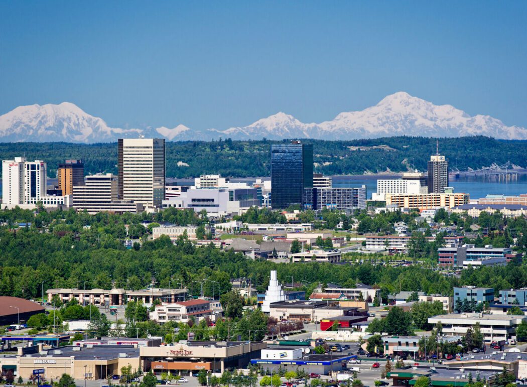 Aerial view of downtown Anchorage with the Alaska Range in the background. Denali is at right.