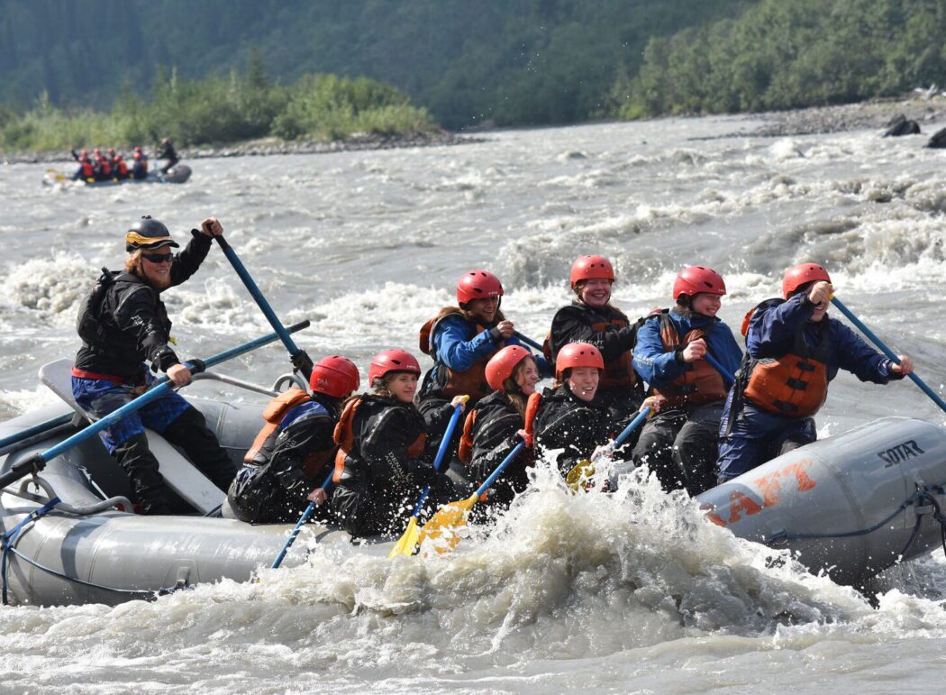 a group of people whitewater rafting in Denali National Park