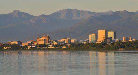 the city skyline of Anchorage, Alaska between mountains and water