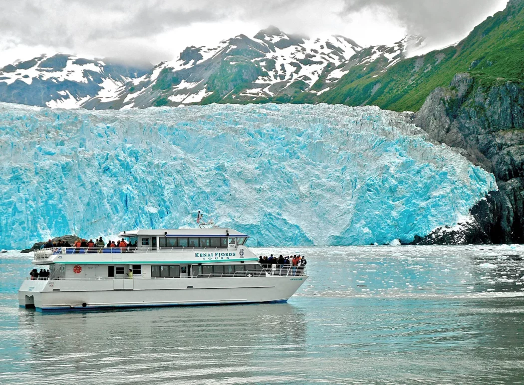 a tour boat in front of a tidewater glacier in Kenai Fjords National Park