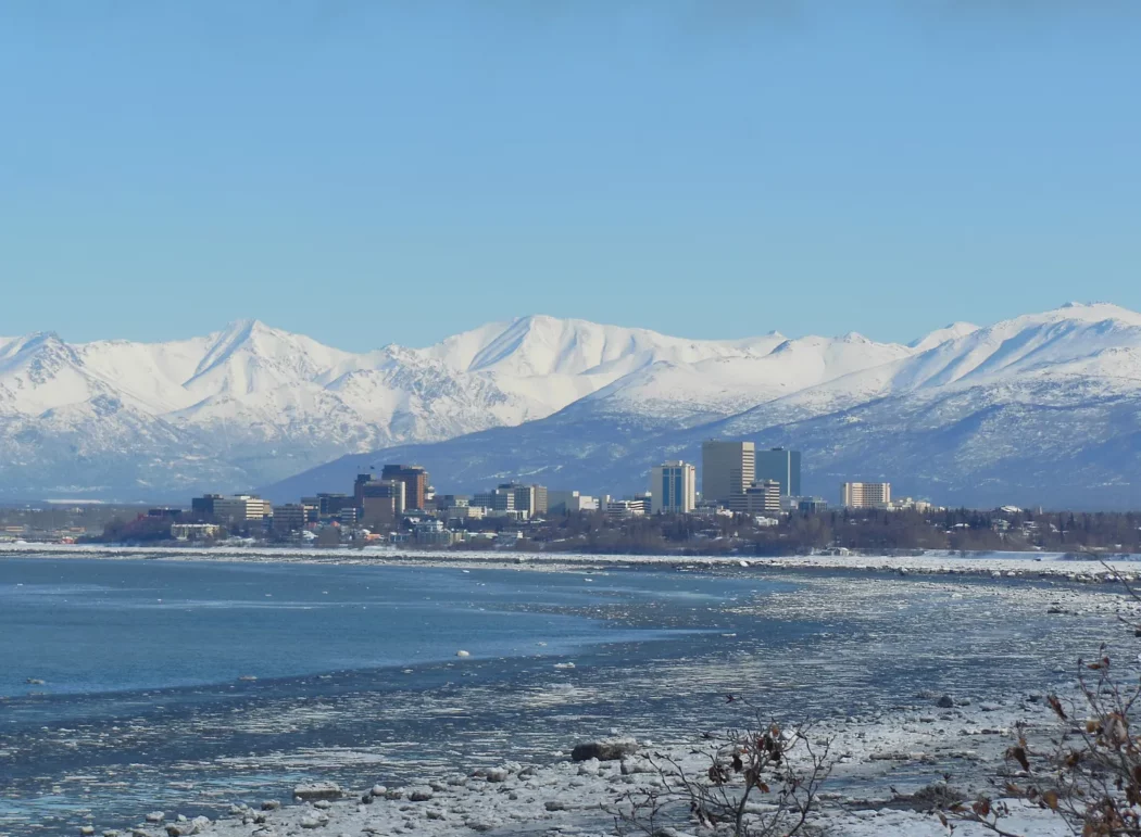 the city skyline of Anchorage, Alaska in winter; mountains in background