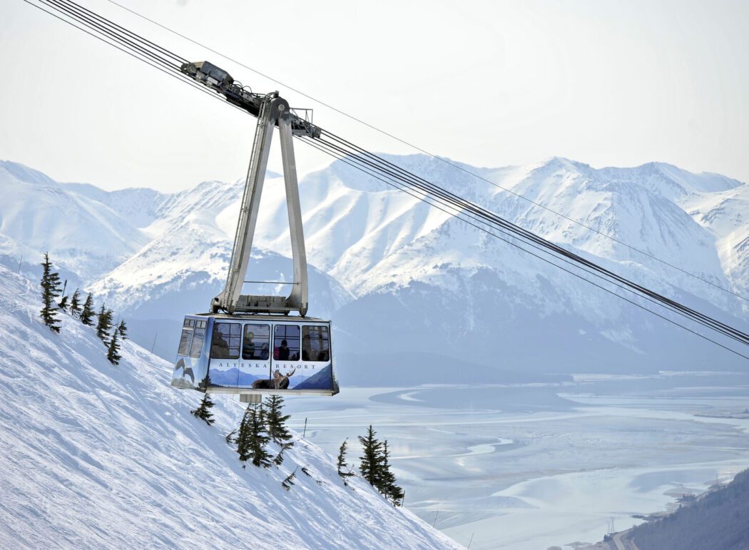 an aerial tram labeled 'Alyeska Resort' over snowy mountains
