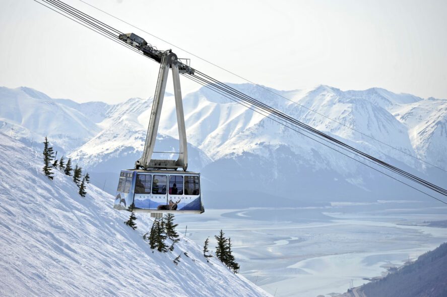an aerial tram labeled 'Alyeska Resort' over snowy mountains