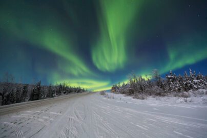 green aurora over the Dalton Highway in Alaska in winter