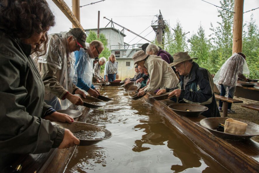 Visitors try their hand panning for gold at Gold Dredge 8.
