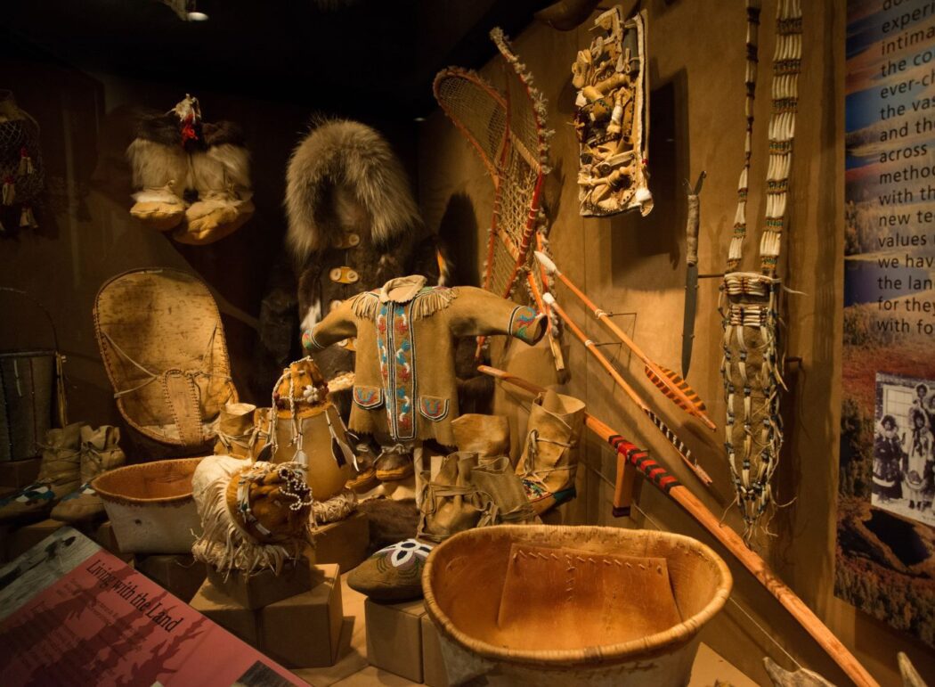 traditional leather clothing, baskets, bow and arrows and other Alaska Native objects on display
