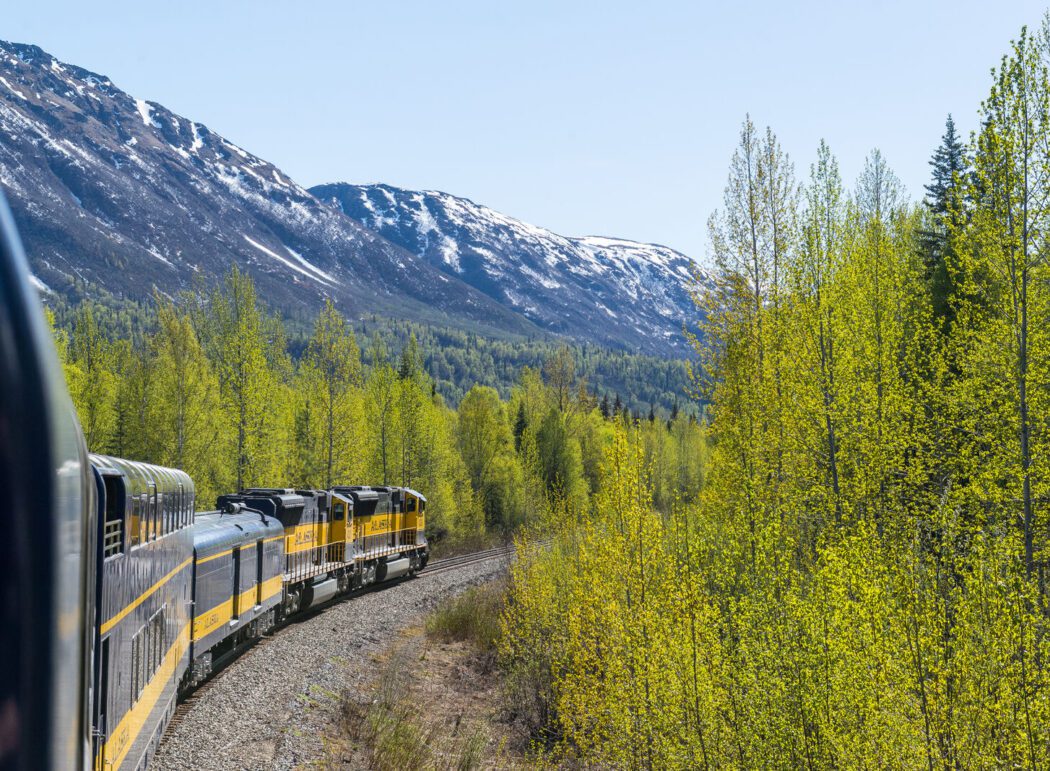 The Alaska Railroad rolls past forested mountains on it's way north out of Anchorage