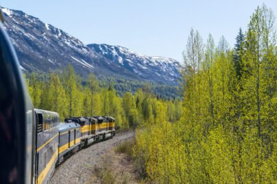 The Alaska Railroad rolls past forested mountains on it's way north out of Anchorage