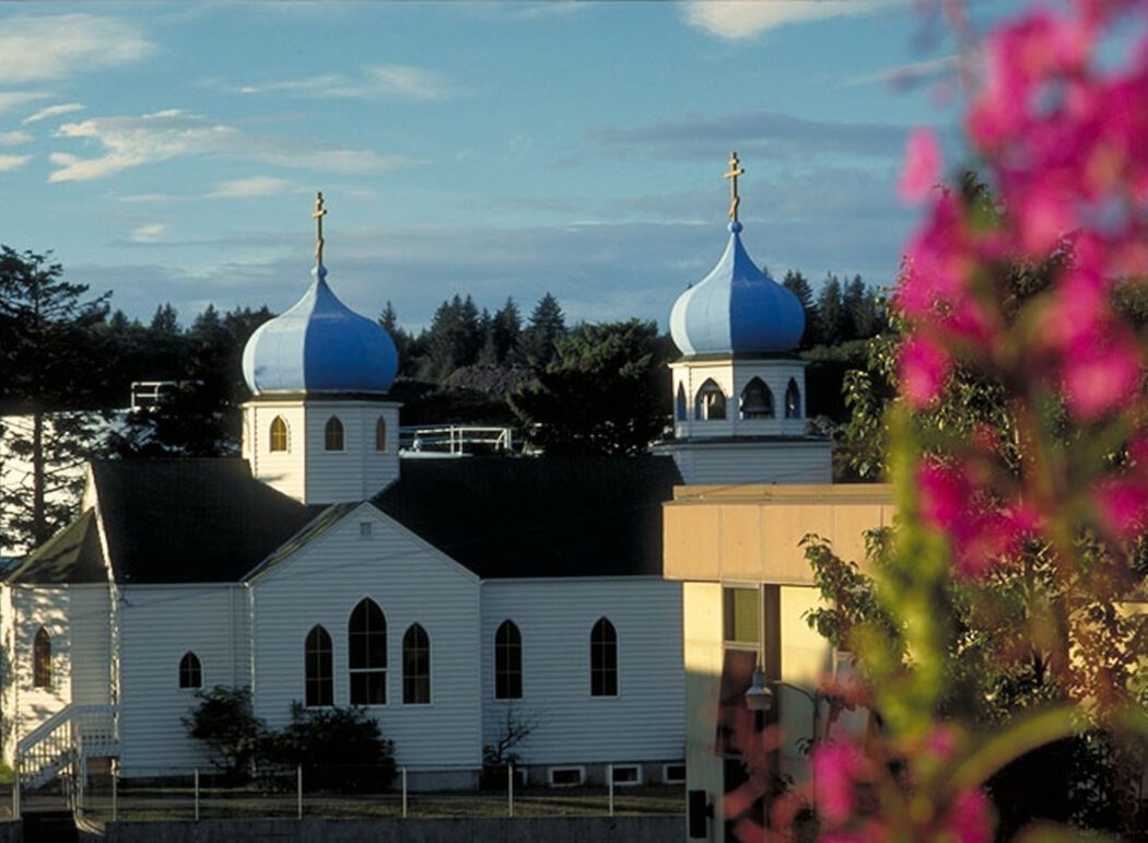 a Russian Orthodox Church with white siding and blue domes