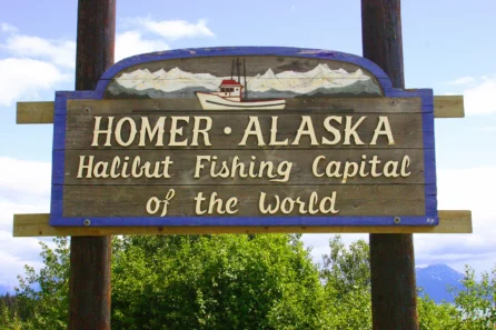 a wooden sign reading "Homer, Alaska: Halibut Fishing Capital of the World"