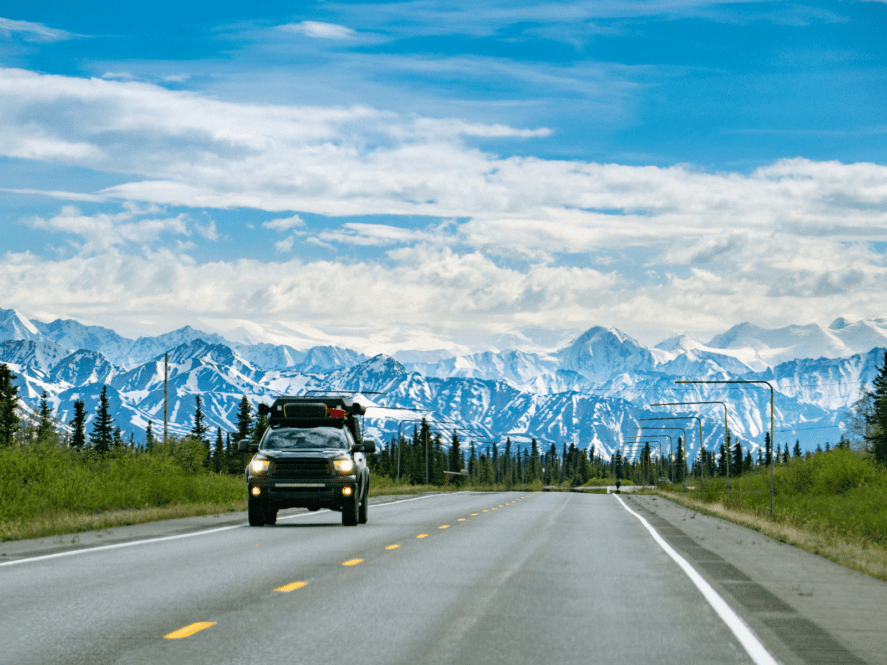 Jeep driving along an Alaska highway