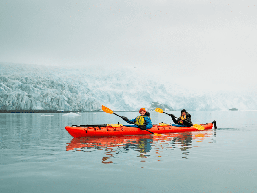 Couple kayaking at Aialik glacier