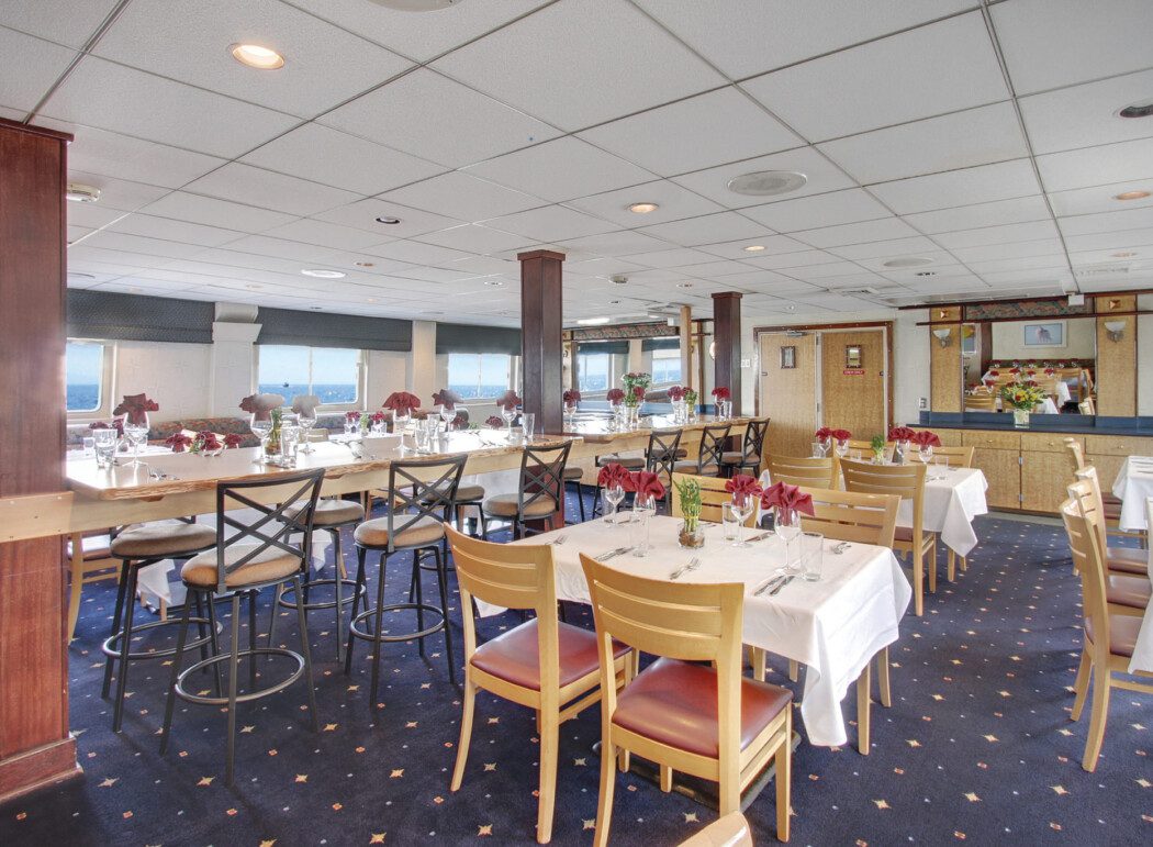 an empty cruise ship dining room with tables set