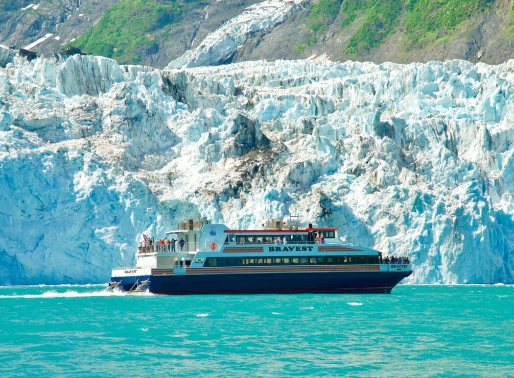 a tour boat along the face of a tidewater glacier in Prince William Sound