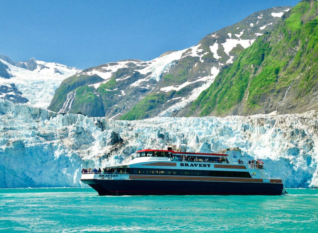 a tour boat named "Bravest" next to a tidewater glacier in Prince William Sound