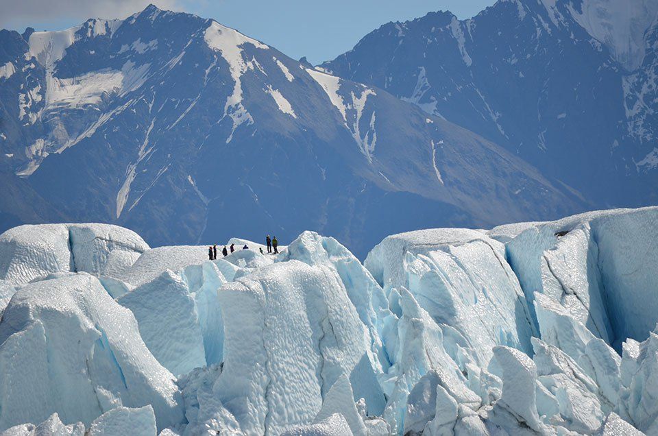 people walking on a valley glacier