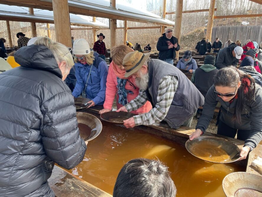 a group of people learning how to pan for gold