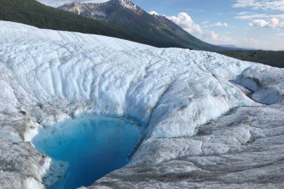 a pool of water atop a glacier
