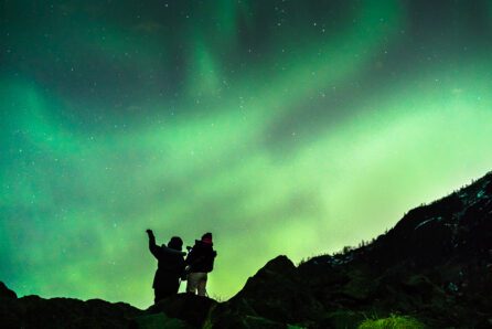 A pair of shutterbugs capture shots of the northern lights outside Anchorage, Alaska. Photo by Jody Overstreet.