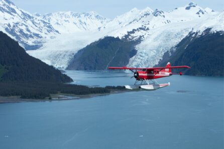 Rust's Flying Service floatplane flying over a fjiord