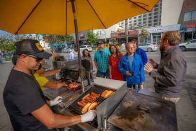 Guests on this Anchorage sightseeing tour taste a reindeer hot dog.