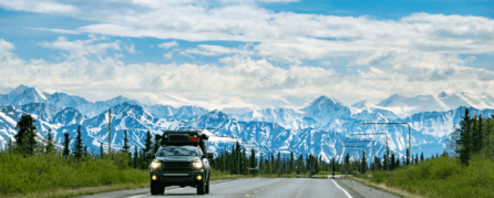 Car driving along an Alaska highway